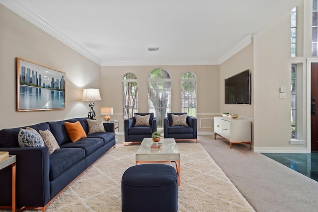 carpeted living area featuring ornamental molding, visible vents, and baseboards