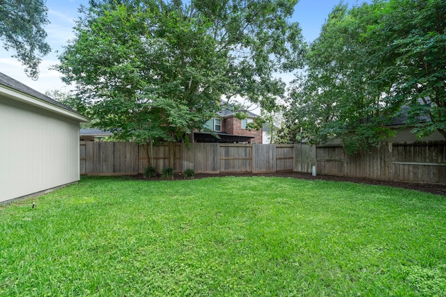 view of yard with a fenced backyard