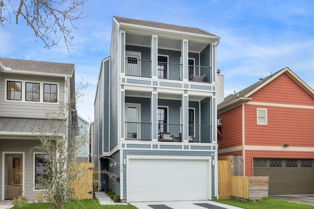 710 E 21st St, Houston, TX 77008 - view of front of property with a standing seam roof, fence, a garage, driveway, and a balcony
