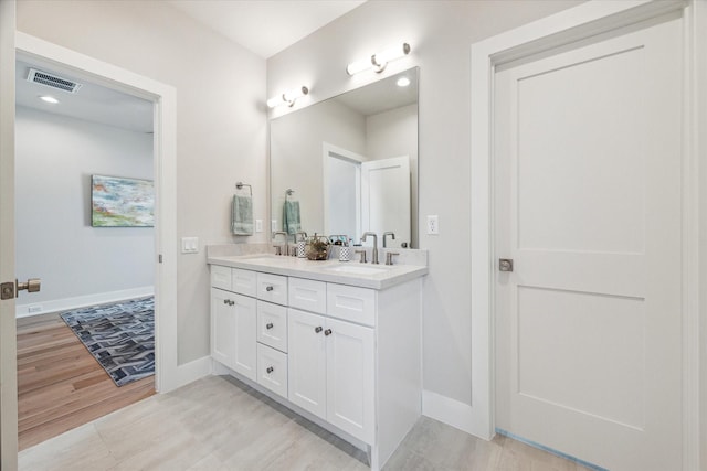 710 E 21st St, Houston, TX 77008 - full bath featuring a sink, double vanity, visible vents, and baseboards
