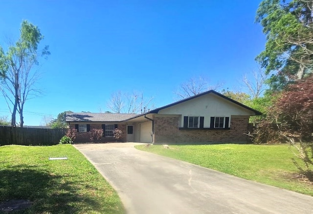 ranch-style house featuring concrete driveway, fence, a front yard, and brick siding