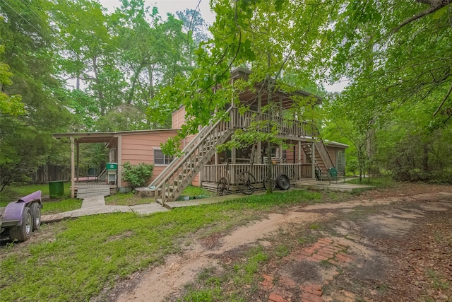 exterior space with a wooden deck and stairs