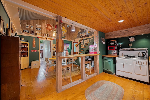 kitchen featuring wood ceiling, green cabinets, range with gas stovetop, and light wood finished floors