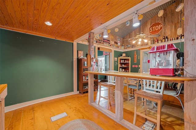 bar featuring visible vents, wood ceiling, lofted ceiling, and wood finished floors