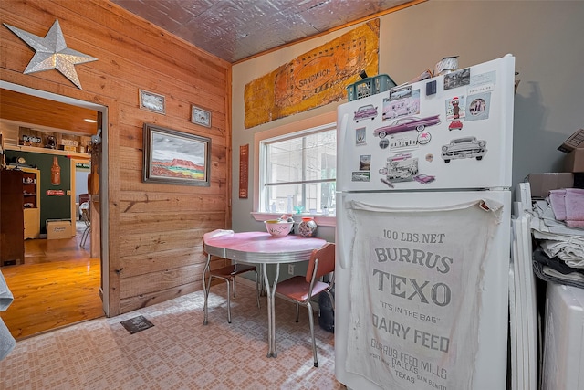 dining space featuring wooden walls