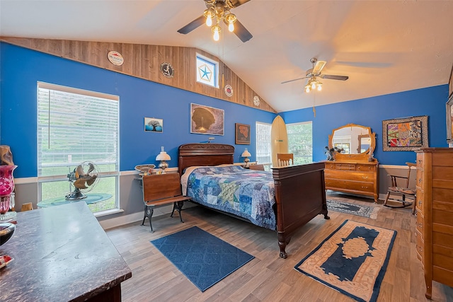 bedroom with a ceiling fan, baseboards, wood finished floors, and lofted ceiling