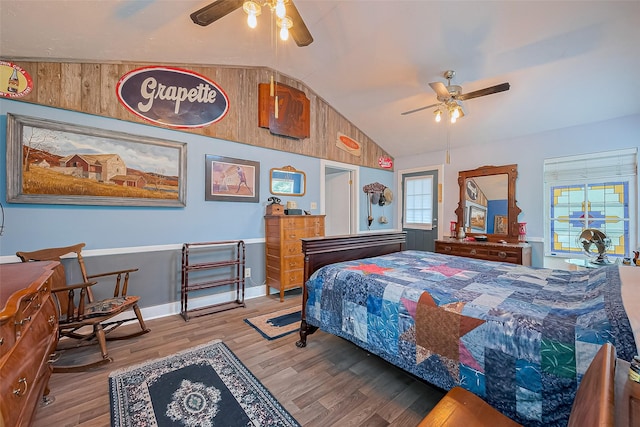 bedroom with baseboards, a ceiling fan, vaulted ceiling, and wood finished floors
