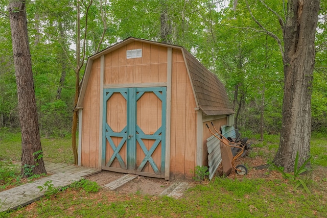 view of shed featuring a view of trees