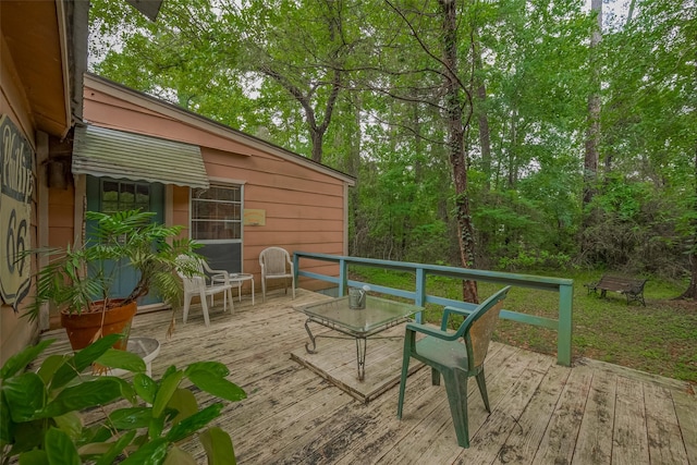 wooden terrace featuring outdoor dining area