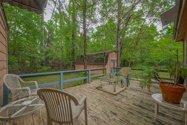 wooden deck with an outbuilding and a shed