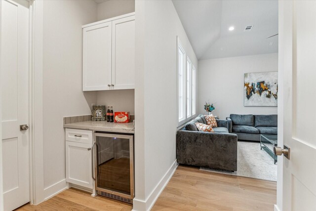 714 E 21st St, Houston, TX 77008 - bar with beverage cooler, a bar, baseboards, recessed lighting, and light wood finished floors
