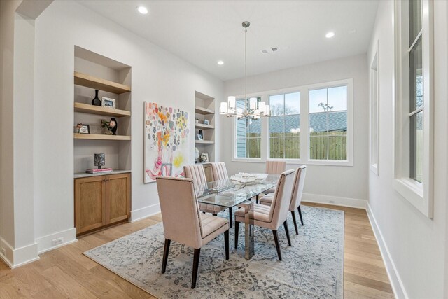 714 E 21st St, Houston, TX 77008 - dining space featuring recessed lighting, a chandelier, light wood-style floors, built in features, and baseboards