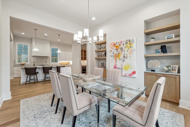 714 E 21st St, Houston, TX 77008 - dining space featuring light wood-type flooring, recessed lighting, and a notable chandelier