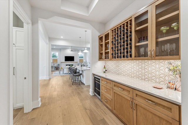 714 E 21st St, Houston, TX 77008 - bar featuring beverage cooler, bar, backsplash, baseboards, and light wood-type flooring