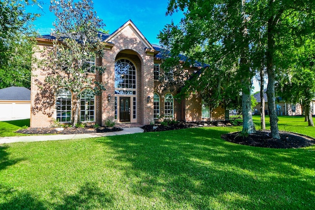 8819 Aubrey Ln, Richmond, TX 77469 - traditional-style home with a front yard, brick siding, and a garage