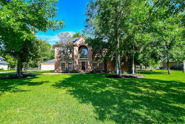 8819 Aubrey Ln, Richmond, TX 77469 - view of front of house with a garage, brick siding, and a front lawn