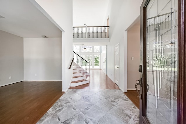 120 Calypso Ln, League City, TX 77573 - foyer entrance featuring stairway, a towering ceiling, wood finished floors, and baseboards