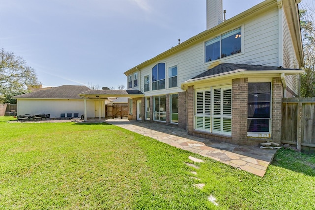 120 Calypso Ln, League City, TX 77573 - back of property with brick siding, a patio area, and a chimney