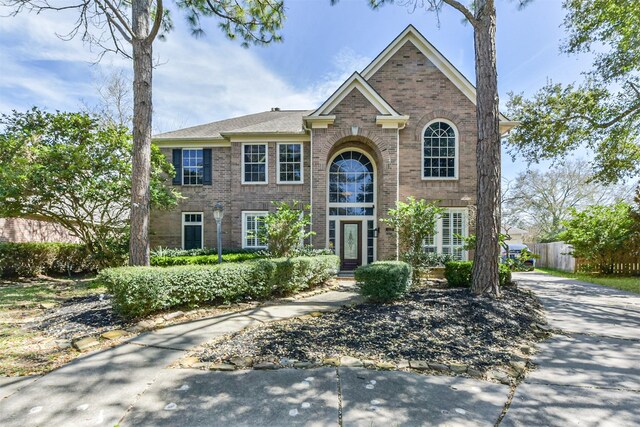 120 Calypso Ln, League City, TX 77573 - traditional-style home featuring brick siding and fence