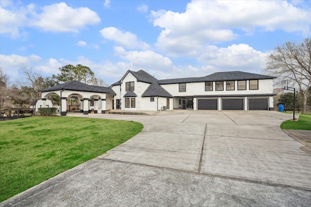 9108 Quail Ridge Dr, Manvel, TX 77578 - view of front of house featuring concrete driveway, a front yard, stucco siding, and a garage