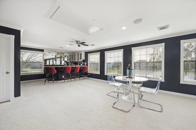 9108 Quail Ridge Dr, Manvel, TX 77578 - dining space with visible vents, a dry bar, attic access, ornamental molding, and carpet