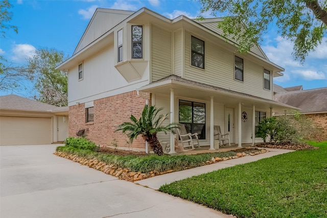 2307 Country Place Dr, Richmond, TX 77406 - view of front of home featuring covered porch, an attached garage, a front lawn, brick siding, and driveway
