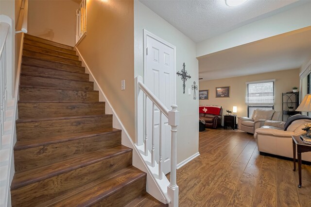 2307 Country Place Dr, Richmond, TX 77406 - staircase with a textured ceiling and wood finished floors