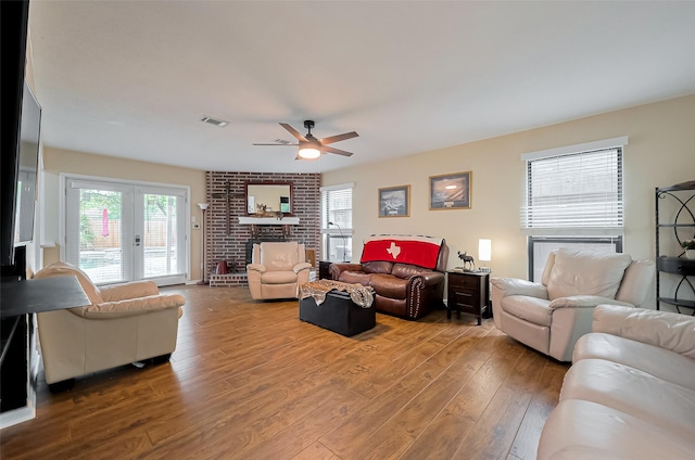 2307 Country Place Dr, Richmond, TX 77406 - living room with ceiling fan, visible vents, a fireplace, and wood-type flooring