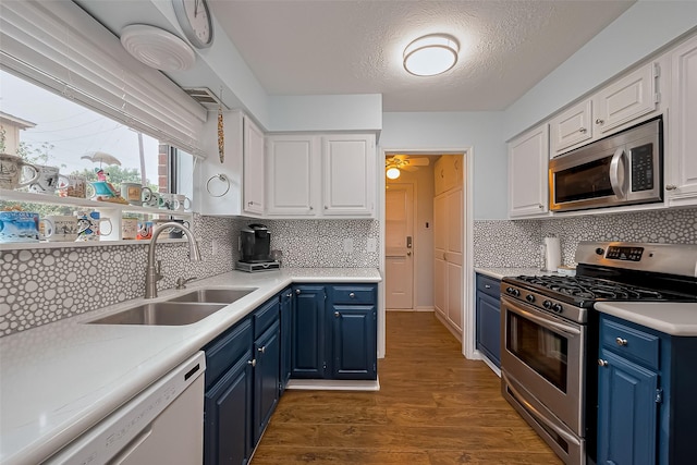 2307 Country Place Dr, Richmond, TX 77406 - kitchen featuring blue cabinets, a sink, white cabinetry, light countertops, and appliances with stainless steel finishes