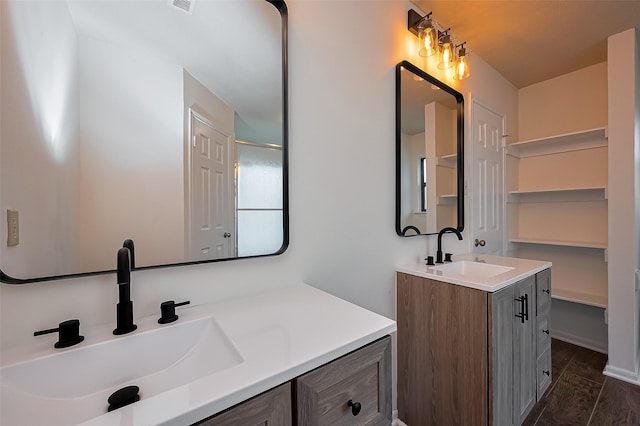 2307 Country Place Dr, Richmond, TX 77406 - bathroom featuring two vanities, a sink, and wood finished floors