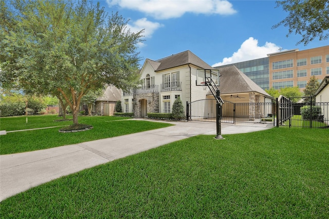 view of front of property with fence, a gate, a front lawn, and stone siding
