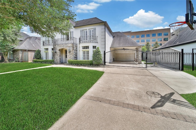 view of front of home featuring fence, a front lawn, stone siding, a gate, and a balcony