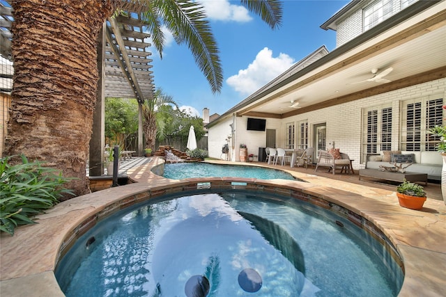 outdoor pool featuring an outdoor hangout area, fence, a patio, and an in ground hot tub