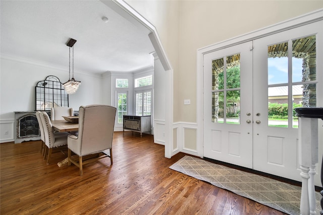 foyer featuring crown molding, wood finished floors, and a notable chandelier