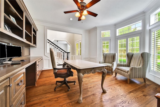 office area with crown molding, a ceiling fan, and a wealth of natural light