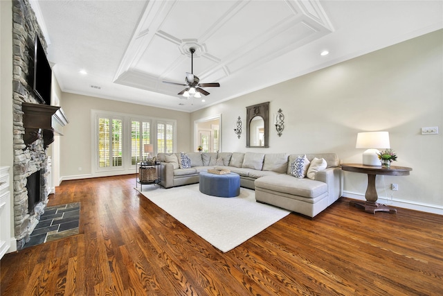 living room featuring visible vents, ornamental molding, a fireplace, ceiling fan, and dark wood-type flooring