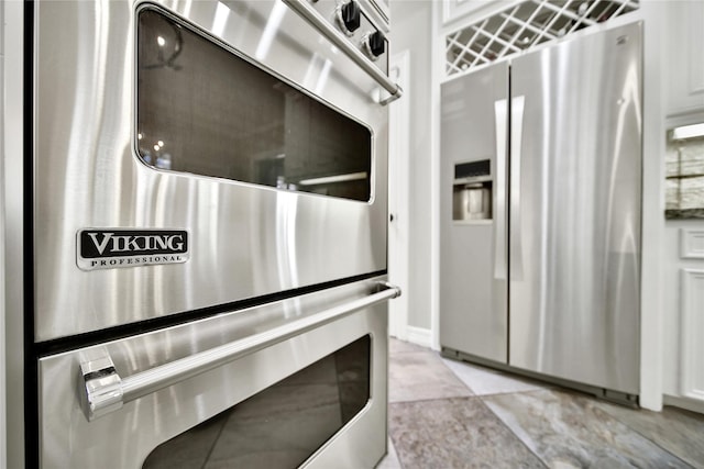 interior space featuring white cabinets and stainless steel appliances