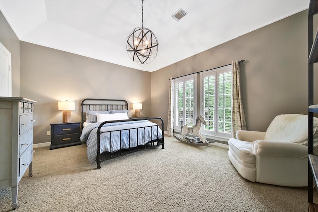 carpeted bedroom featuring an inviting chandelier, baseboards, and visible vents