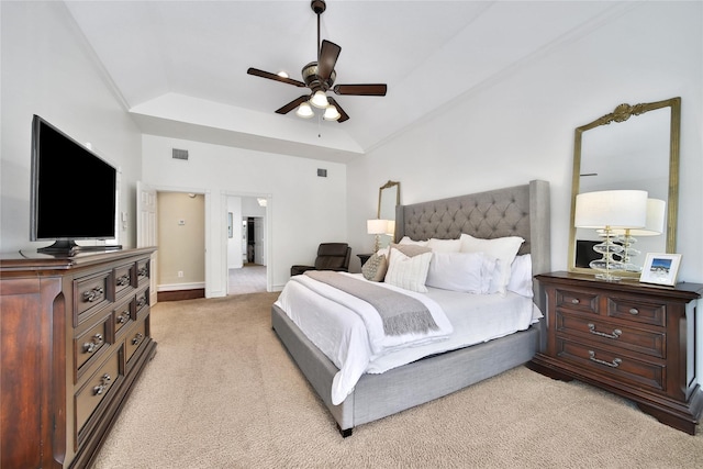 bedroom featuring ceiling fan, light carpet, a raised ceiling, baseboards, and visible vents