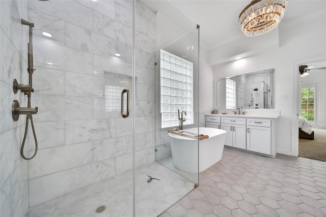 bathroom with a shower stall, vanity, ornamental molding, ensuite bathroom, and a soaking tub