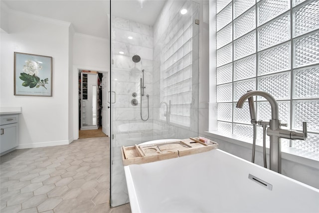 full bath with crown molding, a freestanding tub, baseboards, tile patterned floors, and a tile shower