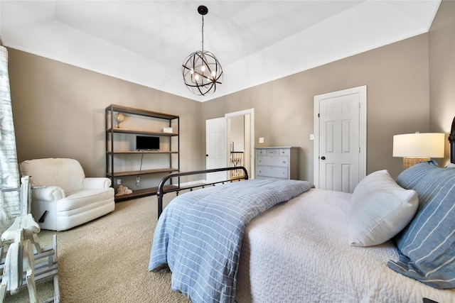 carpeted bedroom featuring a notable chandelier
