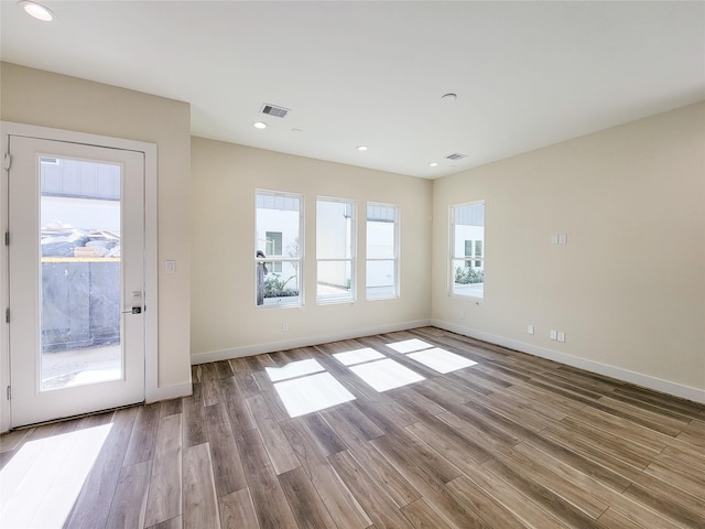 5931 Beall St Unit D, Houston, TX 77091 - unfurnished living room featuring recessed lighting, visible vents, wood finished floors, and baseboards