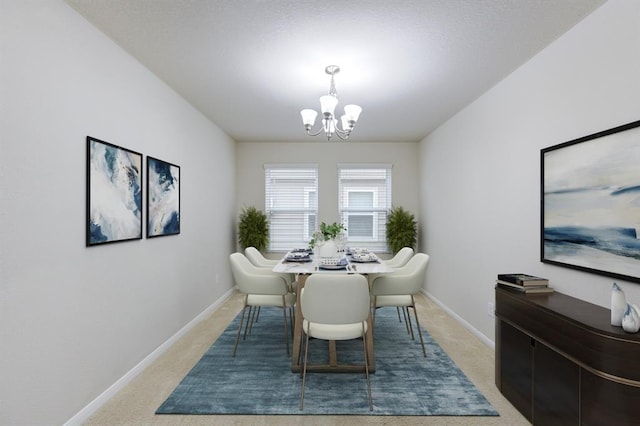 dining area featuring light colored carpet, baseboards, and a notable chandelier