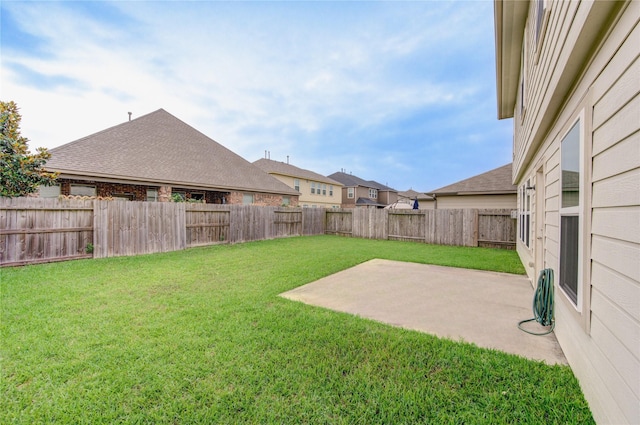 view of yard featuring a patio area and a fenced backyard