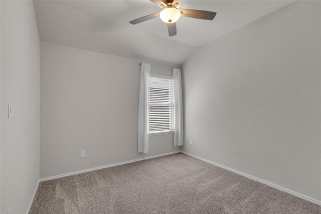 empty room with carpet floors, ceiling fan, baseboards, and lofted ceiling