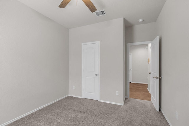 unfurnished bedroom with visible vents, a ceiling fan, baseboards, and carpet floors