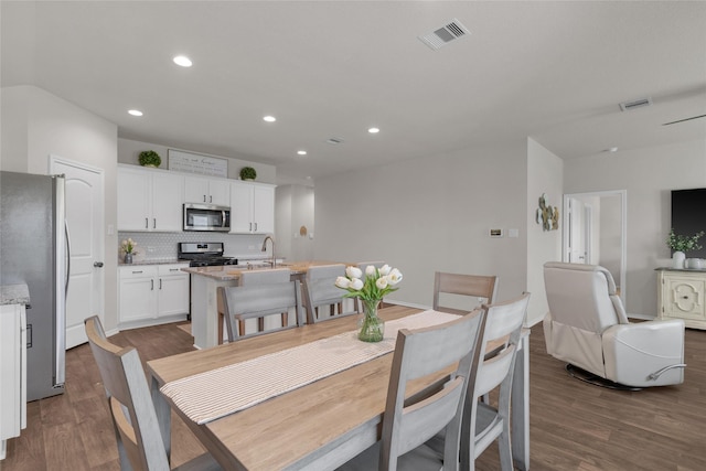 dining room with recessed lighting, dark wood-style flooring, and visible vents