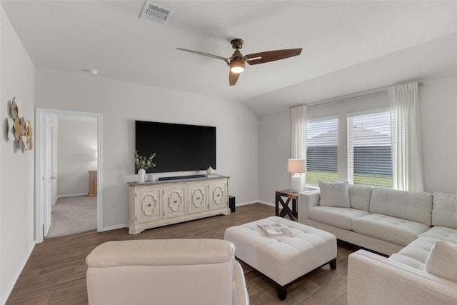 living room featuring a ceiling fan, baseboards, visible vents, and wood finished floors