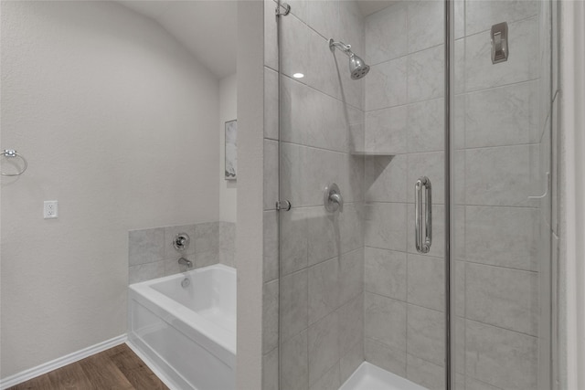 full bath with a garden tub, baseboards, wood finished floors, and a shower stall